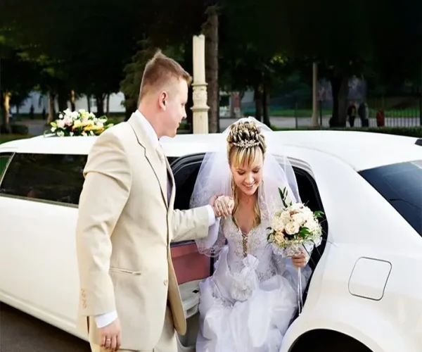 Bride and groom enjoying luxury wedding limousine service in Atlanta with professional chauffeur and elegant transportation